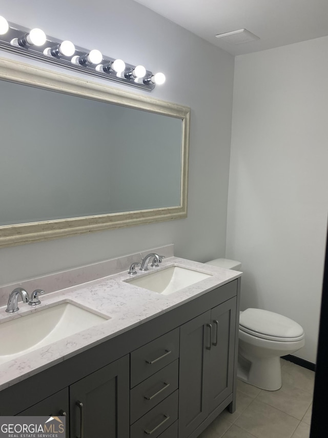 bathroom featuring vanity, toilet, and tile patterned flooring