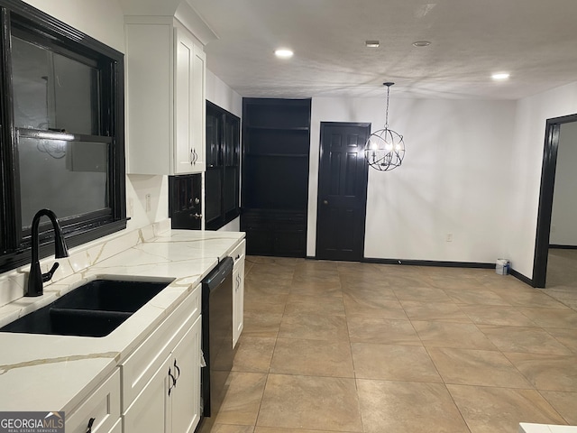 kitchen featuring sink, dishwasher, white cabinetry, light stone counters, and decorative light fixtures