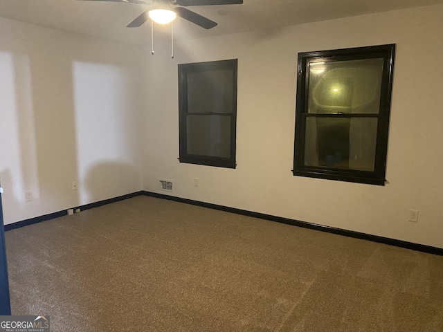 carpeted empty room featuring ceiling fan