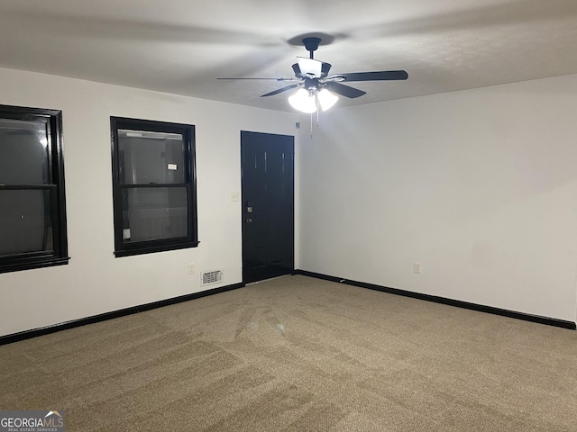 carpeted empty room with ceiling fan