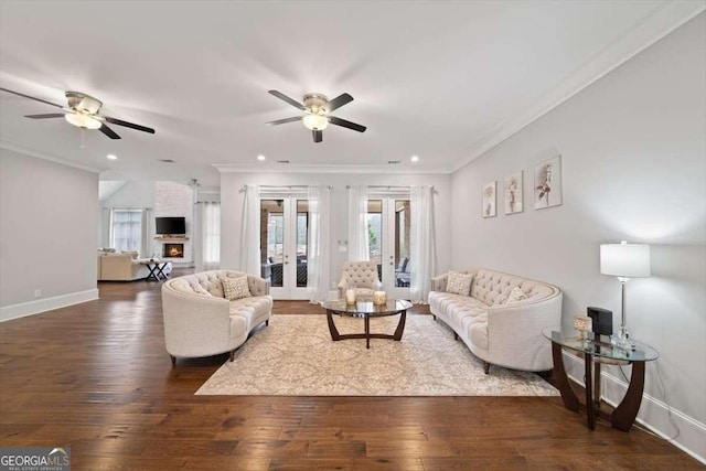 living room with dark hardwood / wood-style floors, ornamental molding, french doors, and ceiling fan