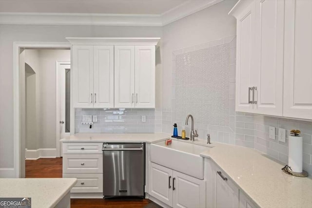 kitchen featuring sink, light stone counters, ornamental molding, white cabinets, and stainless steel dishwasher