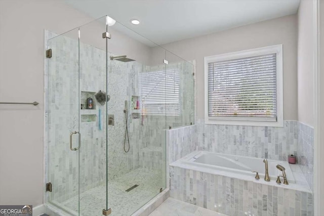 bathroom featuring separate shower and tub