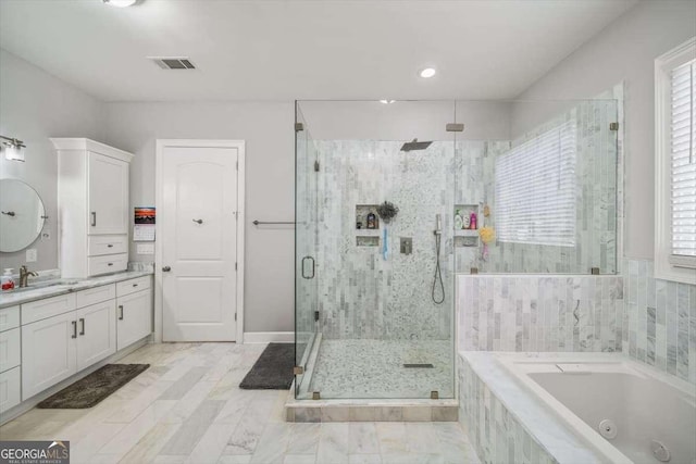 bathroom with vanity and independent shower and bath