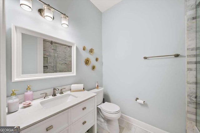 bathroom featuring vanity, toilet, and an enclosed shower