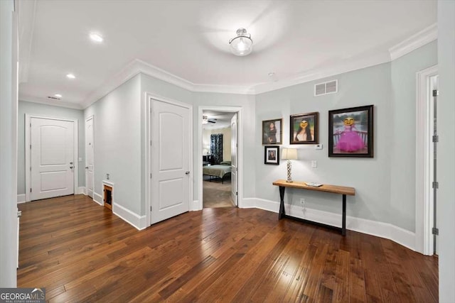 hall featuring dark hardwood / wood-style flooring and crown molding