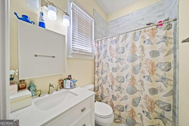 bathroom with vanity, toilet, and walk in shower