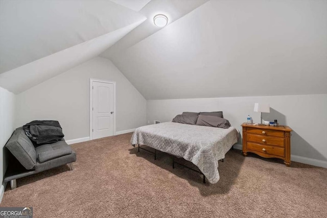 carpeted bedroom featuring lofted ceiling