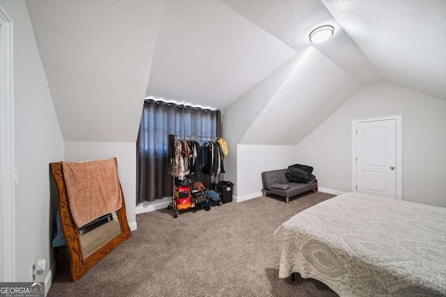 carpeted bedroom with lofted ceiling