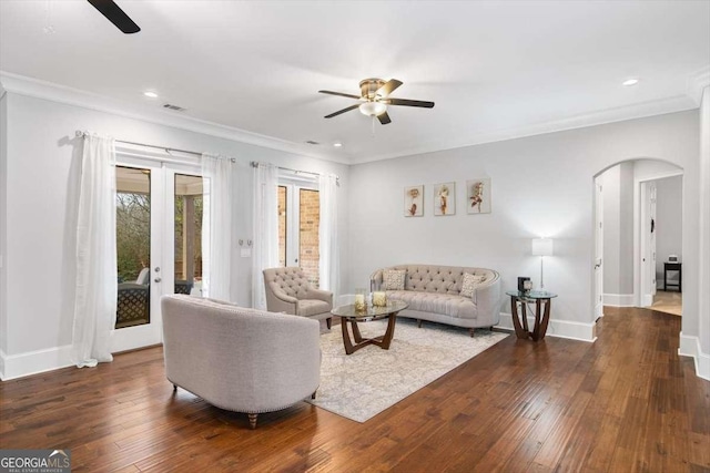 living room featuring crown molding, dark hardwood / wood-style floors, and ceiling fan