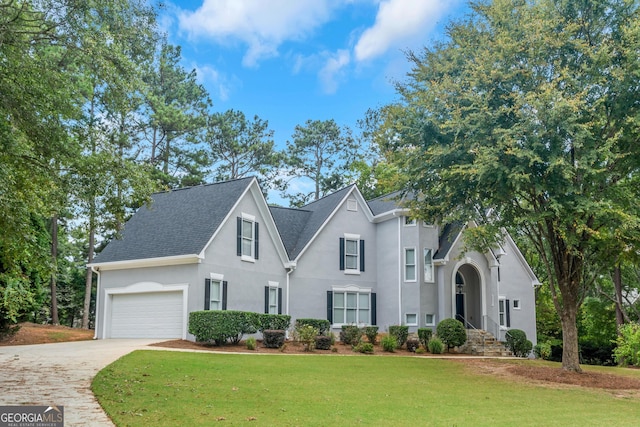 view of front facade featuring a garage and a front lawn