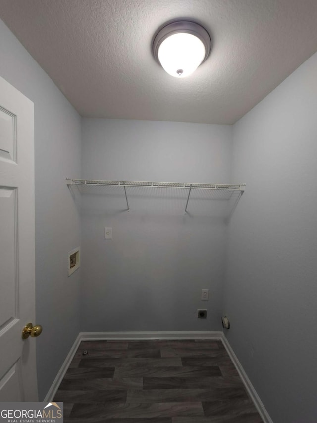 laundry room featuring hookup for a washing machine, dark wood-type flooring, and a textured ceiling