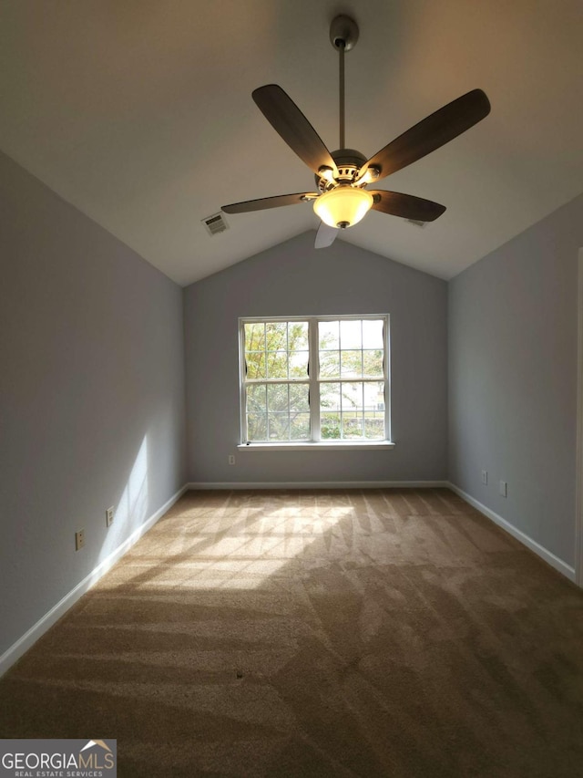 carpeted empty room with lofted ceiling and ceiling fan