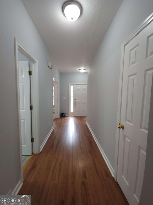 corridor featuring dark hardwood / wood-style flooring