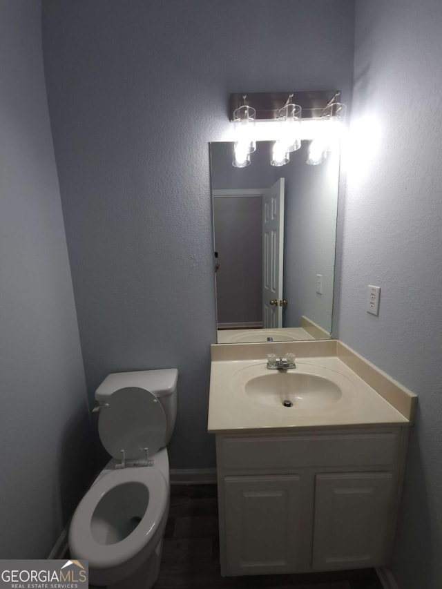 bathroom featuring vanity and toilet