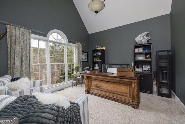 home office with high vaulted ceiling and carpet