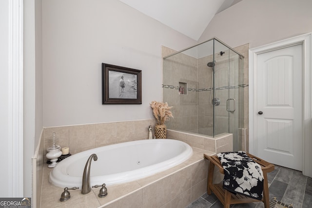 bathroom with lofted ceiling and independent shower and bath