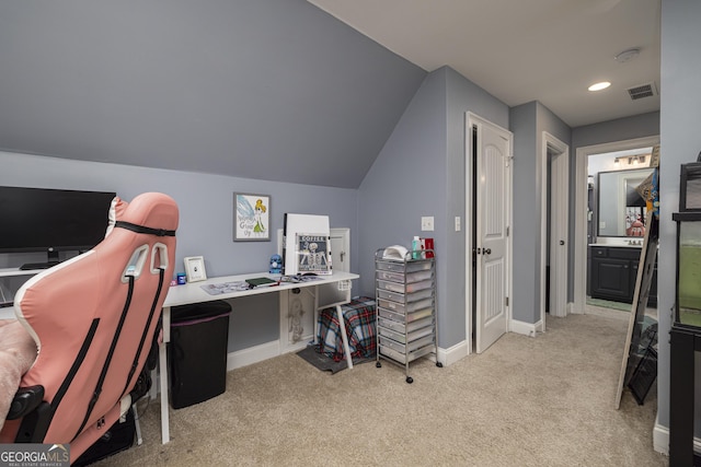 carpeted office space with vaulted ceiling