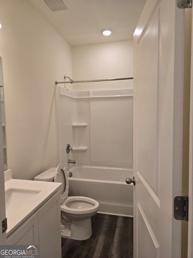 full bathroom featuring shower / bath combination, wood-type flooring, vanity, and toilet