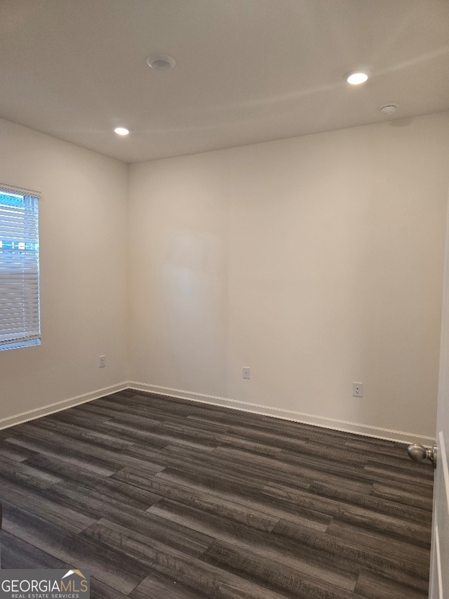 spare room with dark hardwood / wood-style flooring