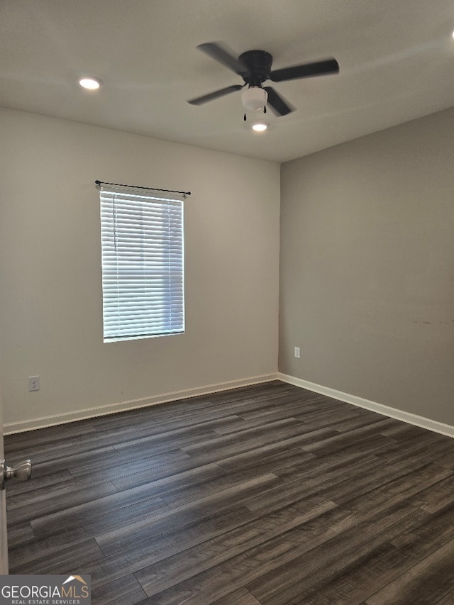 empty room featuring dark wood-type flooring and ceiling fan