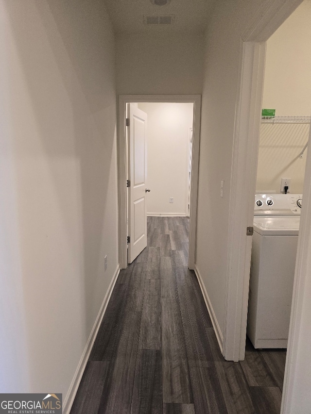 hallway with washer / clothes dryer and dark hardwood / wood-style floors