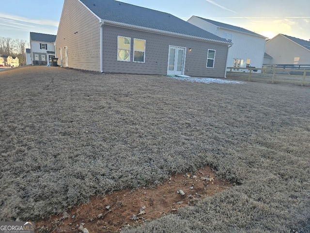 view of back house at dusk