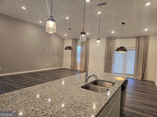 kitchen with pendant lighting, dark hardwood / wood-style floors, sink, and light stone counters