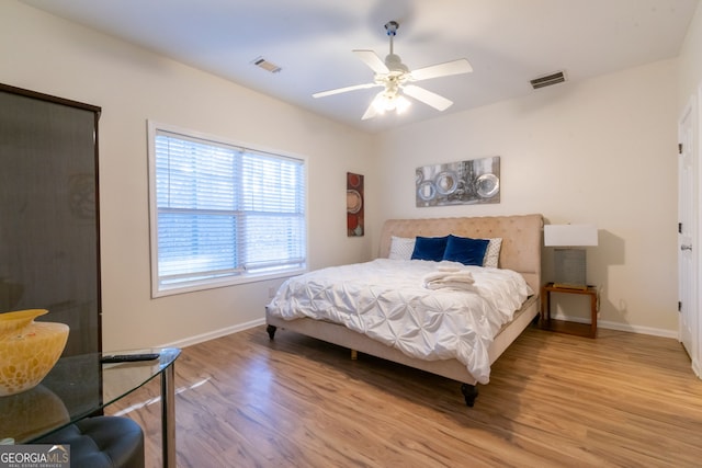 bedroom with light hardwood / wood-style floors and ceiling fan