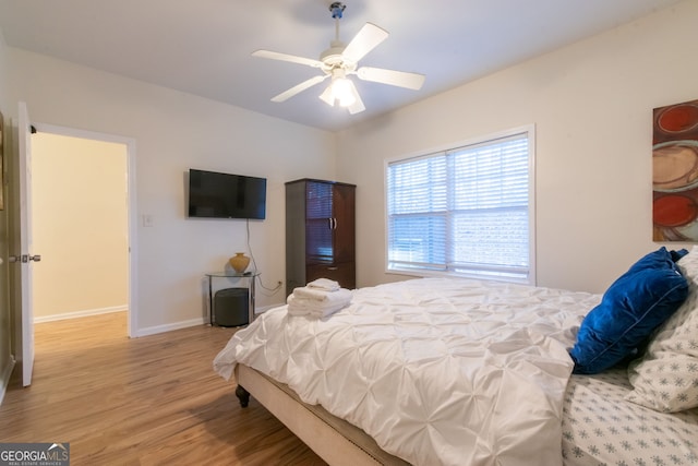 bedroom with hardwood / wood-style floors and ceiling fan