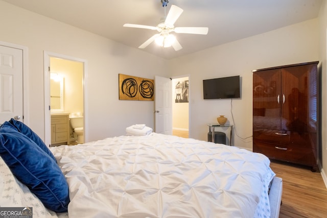 bedroom with ceiling fan, ensuite bathroom, and hardwood / wood-style floors