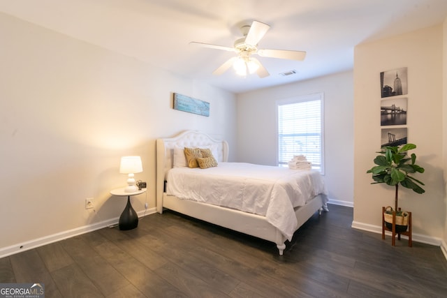 bedroom with dark hardwood / wood-style floors and ceiling fan