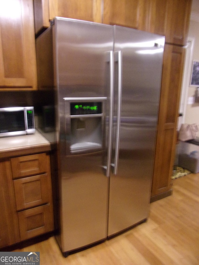 kitchen with stainless steel appliances and light wood-type flooring