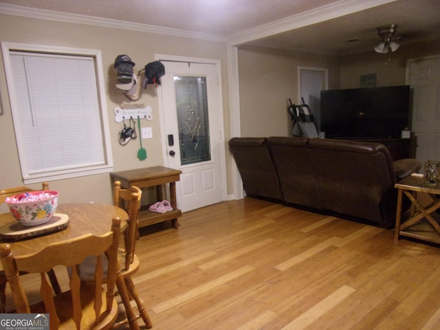 dining room with light hardwood / wood-style flooring, ornamental molding, and ceiling fan