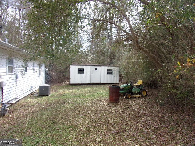 view of yard with a storage shed and central air condition unit