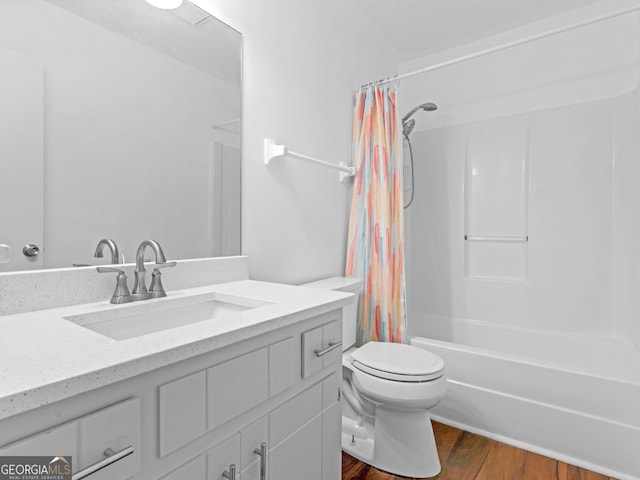 full bathroom featuring shower / tub combo with curtain, vanity, hardwood / wood-style flooring, and toilet