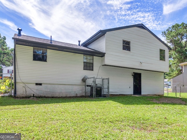 back of house featuring central AC and a yard