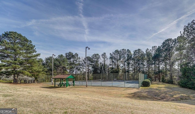 exterior space with a gazebo, a yard, and tennis court