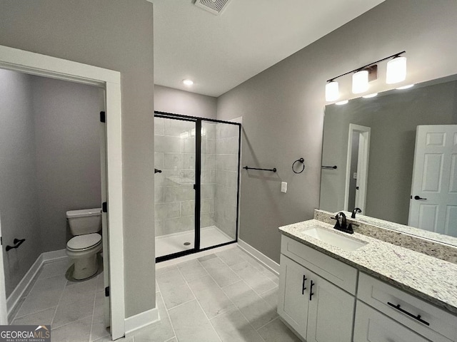 bathroom featuring tile patterned flooring, vanity, an enclosed shower, and toilet