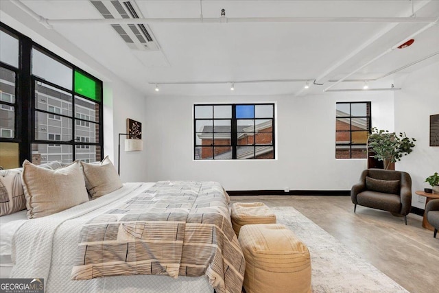 bedroom featuring concrete flooring