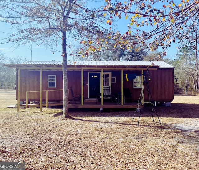 back of property with covered porch