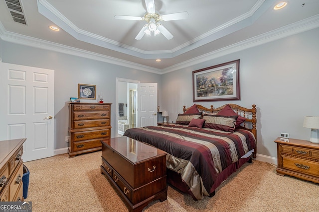 bedroom with crown molding, a tray ceiling, light colored carpet, and ceiling fan