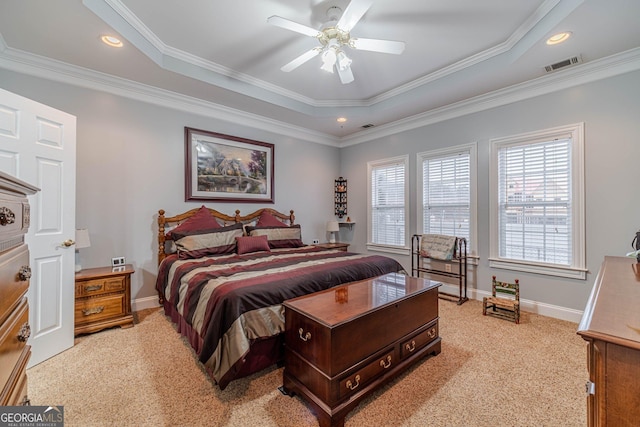 bedroom featuring crown molding, light carpet, ceiling fan, and a tray ceiling