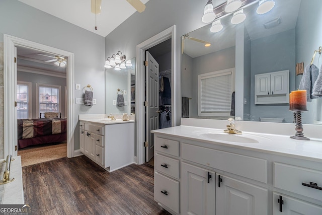 bathroom featuring vanity, hardwood / wood-style floors, crown molding, and ceiling fan