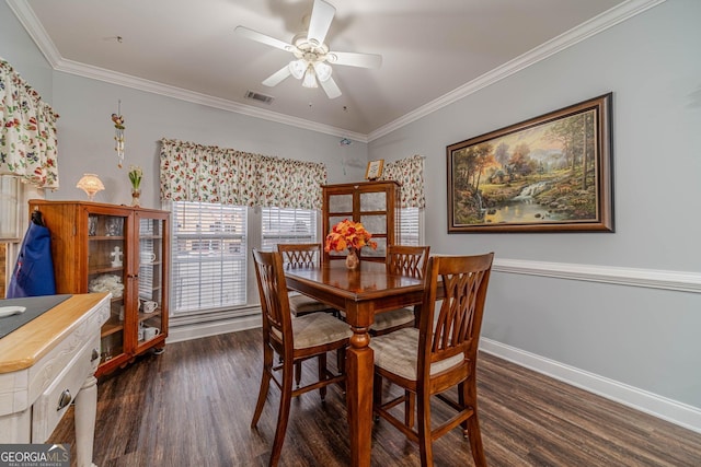 dining space with dark hardwood / wood-style flooring, crown molding, and ceiling fan