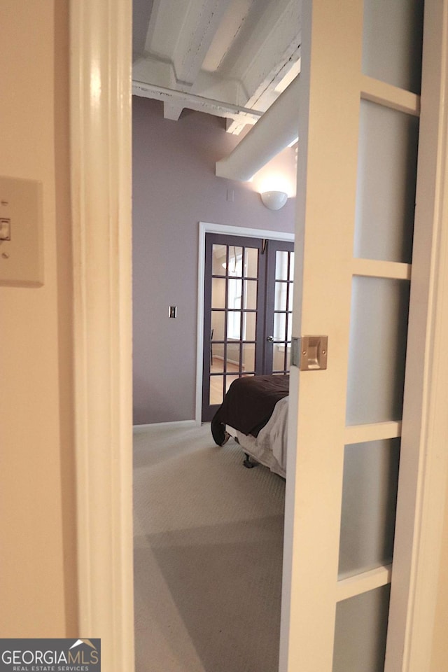 hallway featuring a high ceiling, carpet floors, and french doors