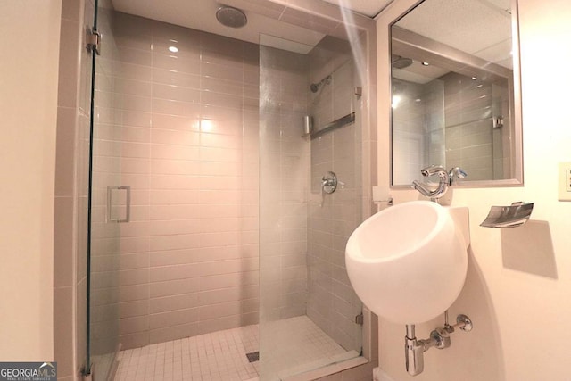 bathroom featuring a shower with shower door