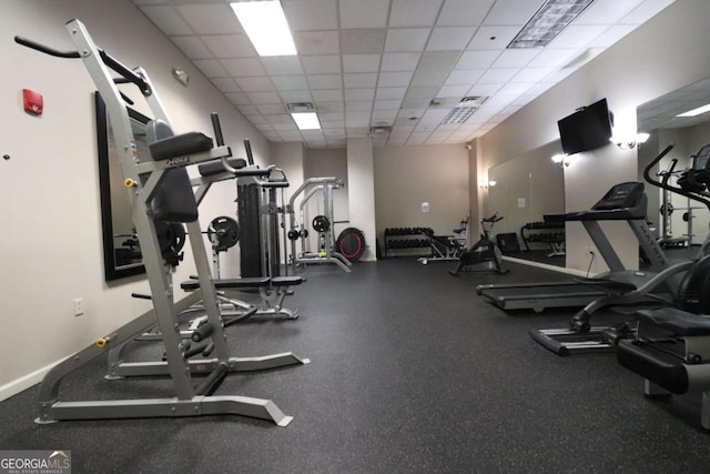 exercise room featuring a paneled ceiling