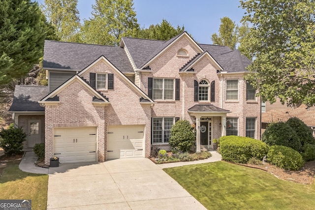 view of front of property with a garage and a front yard