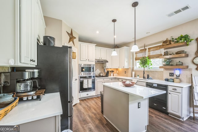 kitchen featuring a kitchen island, dark hardwood / wood-style floors, white cabinets, hanging light fixtures, and stainless steel appliances